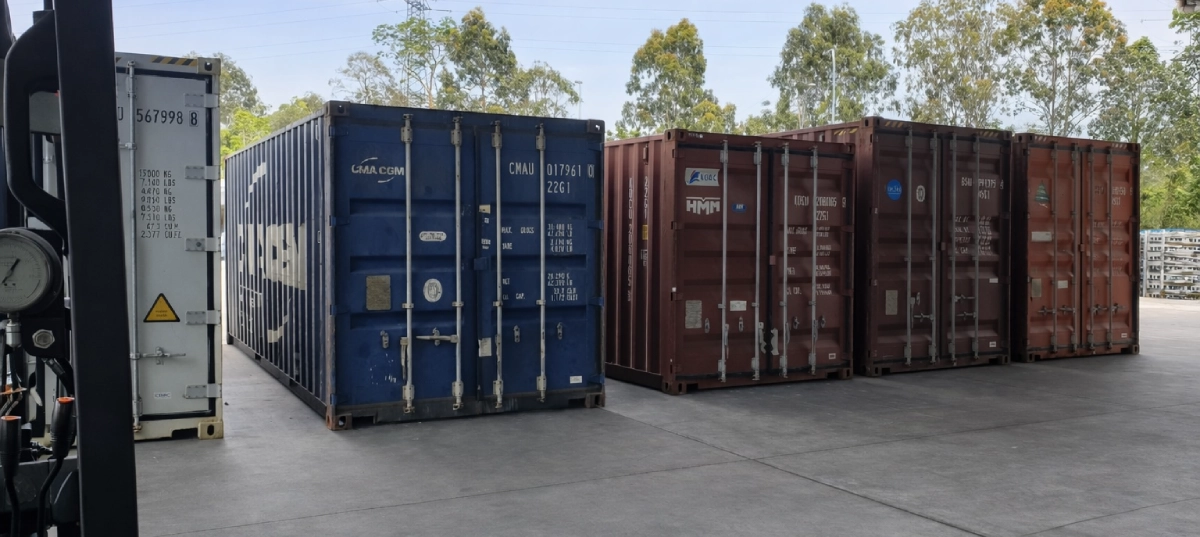 Shipping containers stored at logistics facility ready for transport and distribution