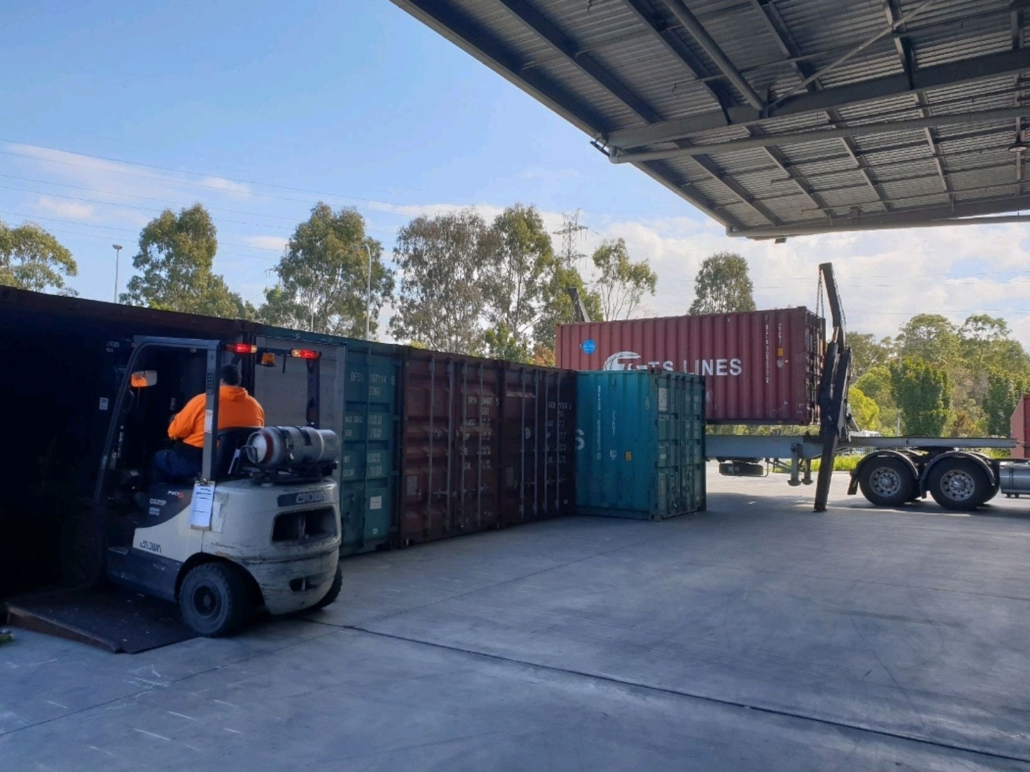Shipping container truck operating at a logistics depot