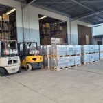 Freight forwarding warehouse with forklifts and palletised goods