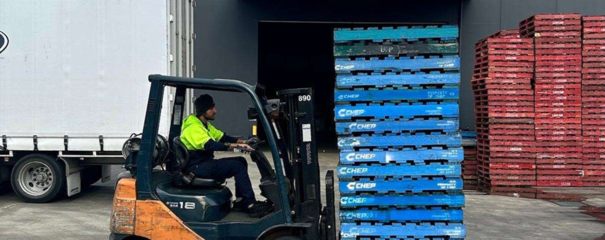 Online fulfilment centre with forklift handling stacked orders beside a delivery truck