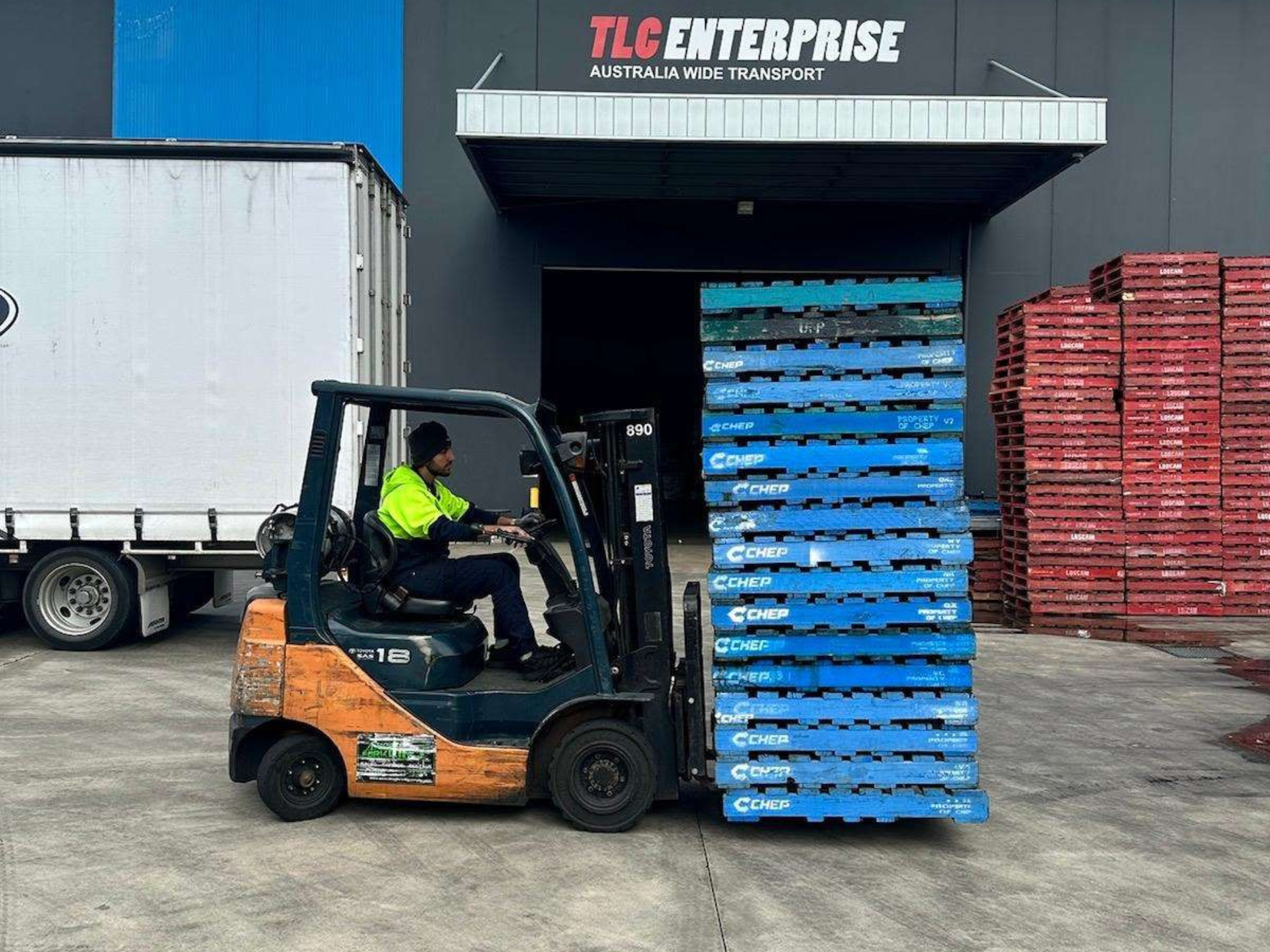 Online fulfilment centre with forklift handling stacked orders beside a delivery truck