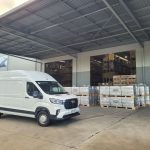 Transportation and warehousing facility with delivery van and palletised goods