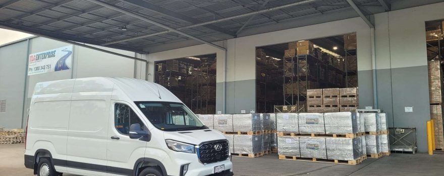 Transportation and warehousing facility with delivery van and palletised goods