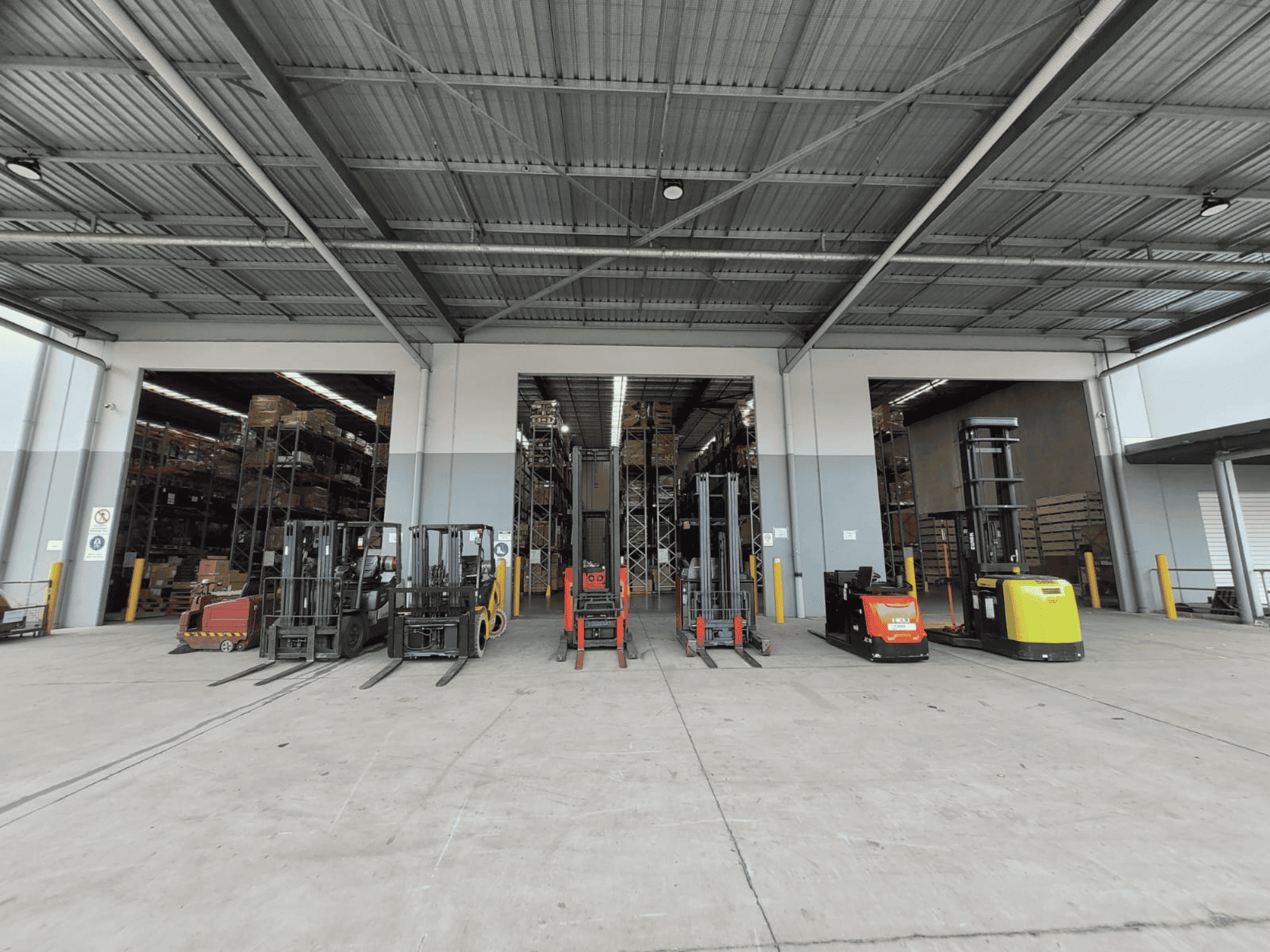 TLC Enterprise warehouse floor with forklifts and material handling equipment supporting warehouse operations
