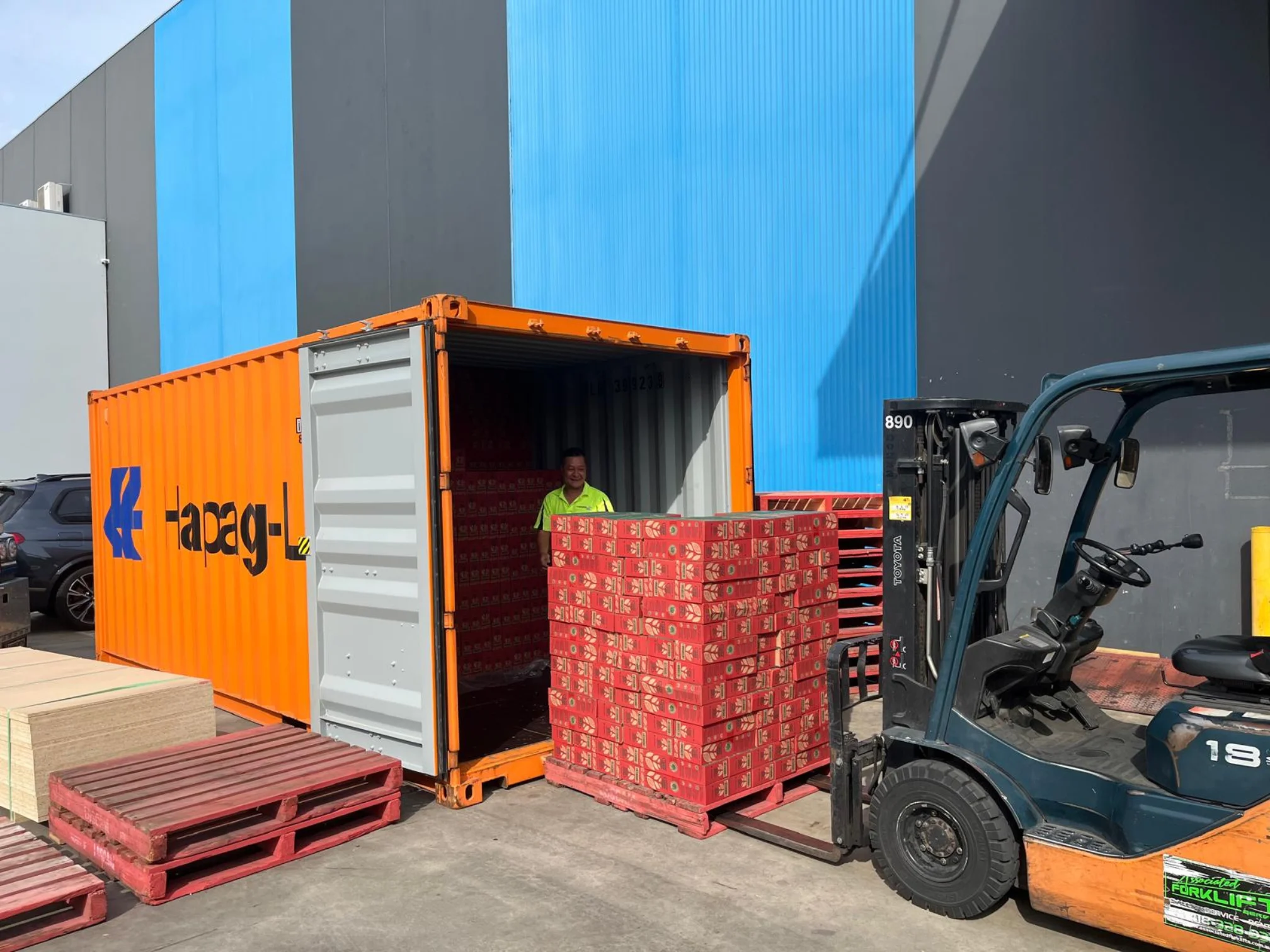 TLC Enterprise loading a shipping container for sea freight with pallet stock